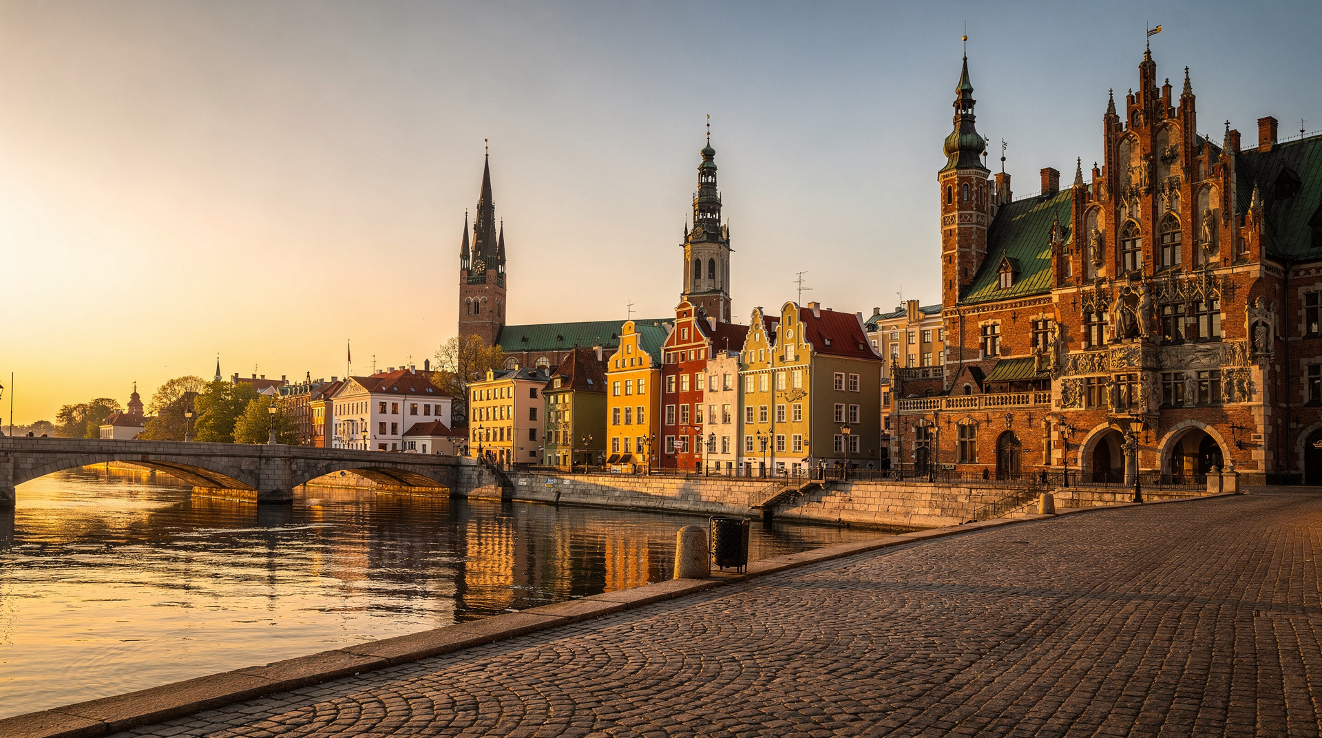 Riga Old Town rooftops and the Daugava river at sunset